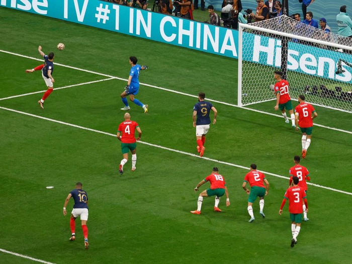 France's defender #22 Theo Hernandez (top) scores his team's first goal during the Qatar 2022 World Cup semi-final football match between France and Morocco at the Al-Bayt Stadium in Al Khor, north of Doha on December 14, 2022. (Photo by Odd ANDERSEN / AFP) (Photo by ODD ANDERSEN/AFP via Getty Images)