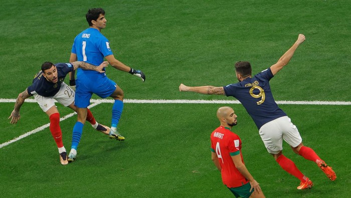 France's defender #22 Theo Hernandez (L) celebrates scoring his team's first goal with France's forward #09 Olivier Giroud during the Qatar 2022 World Cup semi-final football match between France and Morocco at the Al-Bayt Stadium in Al Khor, north of Doha on December 14, 2022. (Photo by Odd ANDERSEN / AFP) (Photo by ODD ANDERSEN/AFP via Getty Images)
