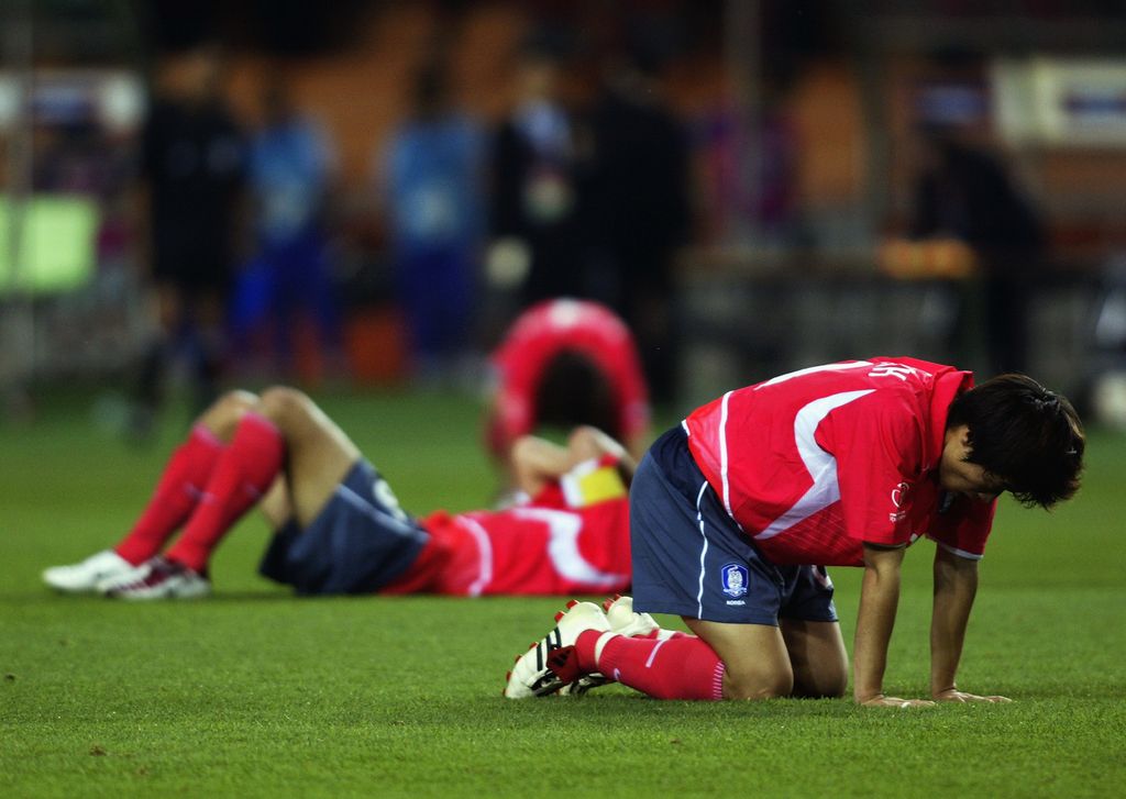 DAEGU - JUNE 29:  Dejected South Korea players after the FIFA World Cup Finals 2002 Third Place Play-Off match between South Korea and Turkey played at the Daegu World Cup Stadium, in Daegu, South Korea on June 29, 2002. Turkey won the match 3-2. DIGITAL IMAGE. (Photo by Gary M. Prior/Getty Images)