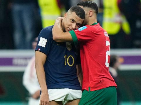 Kylian Mbappe centre-forward of France and Paris Saint-Germain and Achraf Hakimi right-back of Morocco and Paris Saint-Germain greet each other after the FIFA World Cup Qatar 2022 semi final match between France and Morocco at Al Bayt Stadium on December 14, 2022 in Al Khor, Qatar. (Photo by Jose Breton/Pics Action/NurPhoto via Getty Images)