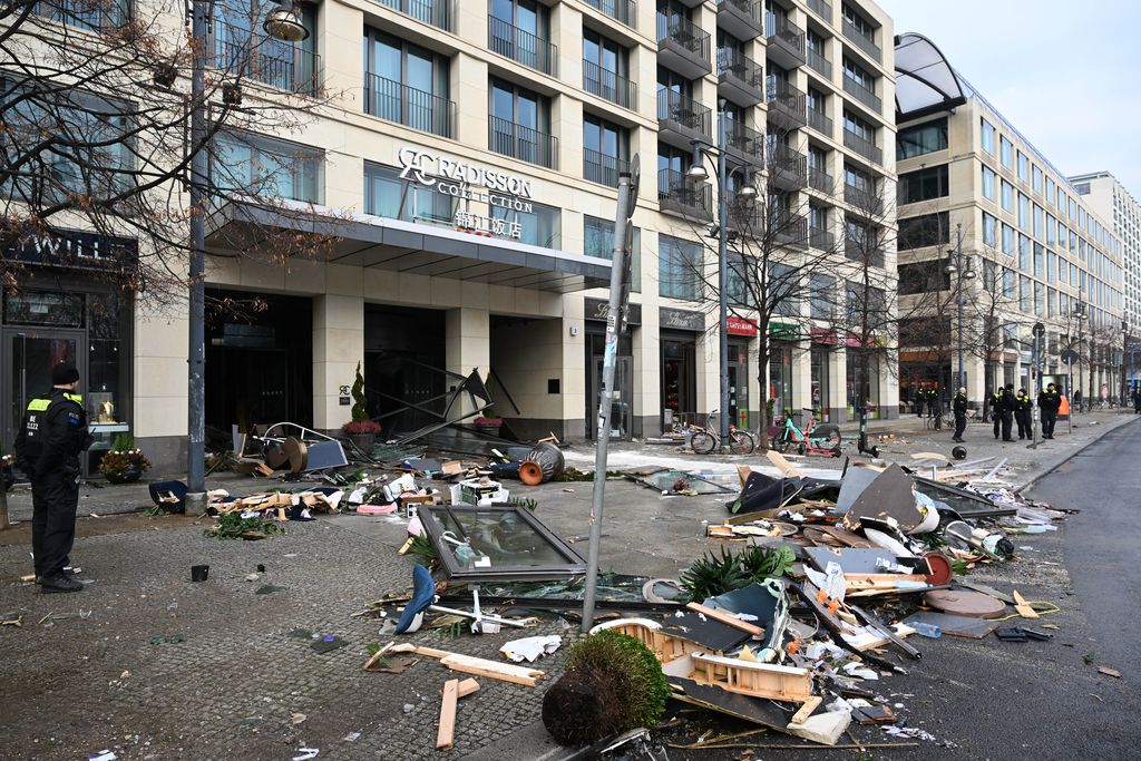 16 December 2022, Berlin: A police officer stands outside the entrance to Sea Life at the Radisson Hotel in front of the wreckage. In the morning, the aquarium in the hotel lobby had broken apart. Photo: Soeren Stache/dpa (Photo by Soeren Stache/picture alliance via Getty Images)