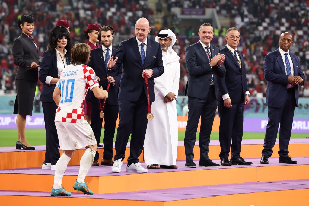 DOHA, QATAR - DECEMBER 17: Gianni Infantino, president of FIFA, presents Luka Modric of Croatia with his bronze medal during the FIFA World Cup Qatar 2022 3rd Place match between Croatia and Morocco at Khalifa International Stadium on December 17, 2022 in Doha, Qatar. (Photo by Alex Livesey - Danehouse/Getty Images)