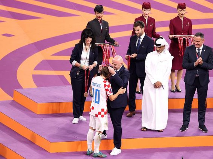 DOHA, QATAR - DECEMBER 17: Luka Modric of Croatia is presented with their FIFA World Cup Qatar 2022 third placed medal after the team's victory by Gianni Infantino, President of FIFA, during the FIFA World Cup Qatar 2022 3rd Place match between Croatia and Morocco at Khalifa International Stadium on December 17, 2022 in Doha, Qatar. (Photo by Julian Finney/Getty Images)
