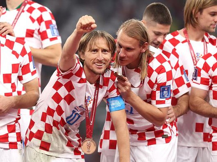 DOHA, QATAR - DECEMBER 17: Luka Modric of Croatia celebrates with their FIFA World Cup Qatar 2022 third placed medal after the team's victory during the FIFA World Cup Qatar 2022 3rd Place match between Croatia and Morocco at Khalifa International Stadium on December 17, 2022 in Doha, Qatar. (Photo by Catherine Ivill/Getty Images)