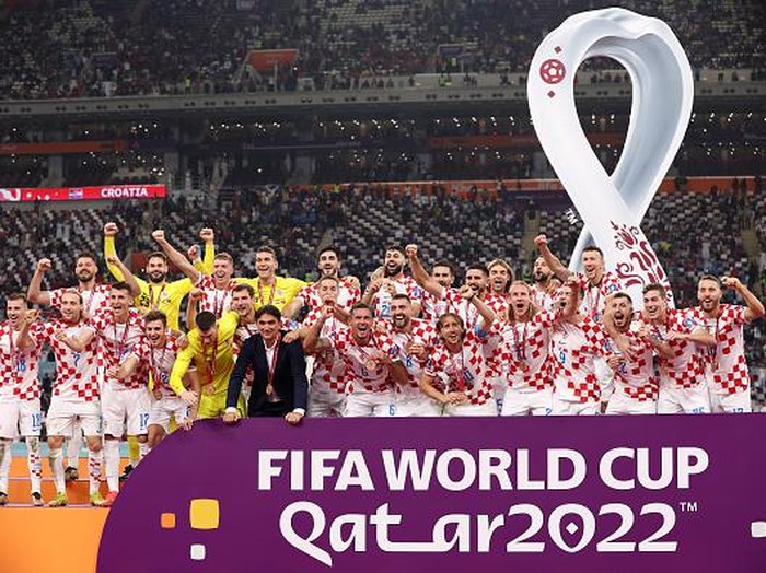 DOHA, QATAR - DECEMBER 17: Croatia players and team officials celebrate with their FIFA World Cup Qatar 2022 third placed medals after the team's victory during the FIFA World Cup Qatar 2022 3rd Place match between Croatia and Morocco at Khalifa International Stadium on December 17, 2022 in Doha, Qatar. (Photo by Clive Brunskill/Getty Images)