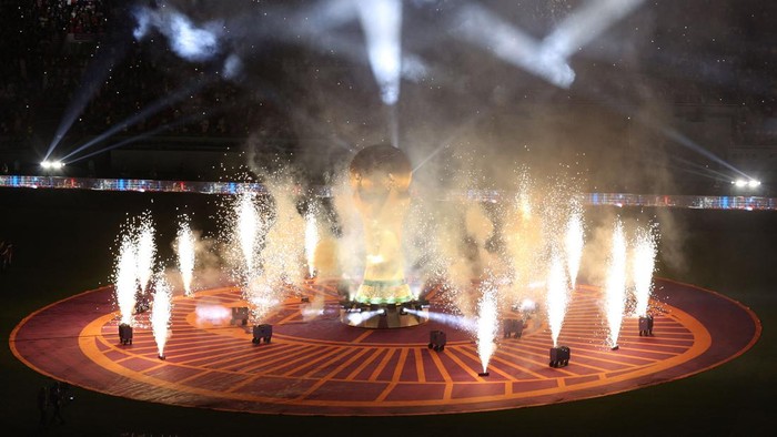 Fireworks go off around a FIFA World Cup trophy replica prior to the Qatar 2022 World Cup football third place play-off match between Croatia and Morocco at Khalifa International Stadium in Doha on December 17, 2022. (Photo by ADRIAN DENNIS / AFP) (Photo by ADRIAN DENNIS/AFP via Getty Images)