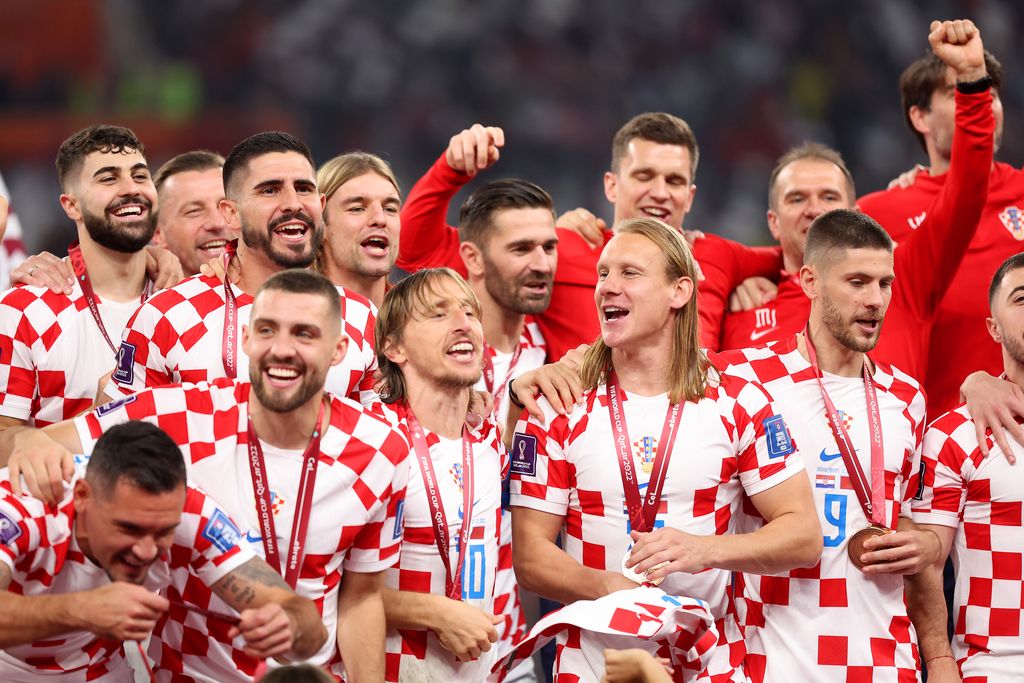 DOHA, QATAR - DECEMBER 17: Luka Modric of Croatia and teammates celebrate with their FIFA World Cup Qatar 2022 third placed medals after the team's victory during the FIFA World Cup Qatar 2022 3rd Place match between Croatia and Morocco at Khalifa International Stadium on December 17, 2022 in Doha, Qatar. (Photo by Catherine Ivill/Getty Images)