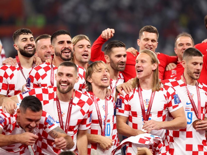 DOHA, QATAR - DECEMBER 17: Luka Modric of Croatia and teammates celebrate with their FIFA World Cup Qatar 2022 third placed medals after the team's victory during the FIFA World Cup Qatar 2022 3rd Place match between Croatia and Morocco at Khalifa International Stadium on December 17, 2022 in Doha, Qatar. (Photo by Catherine Ivill/Getty Images)