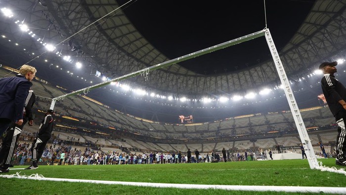 Soccer Football - FIFA World Cup Qatar 2022 - Final - Argentina v France - Lusail Stadium, Lusail, Qatar - December 18, 2022 General view after Argentina fans remove the net from a goal during celebrations on the pitch after the match REUTERS/Kai Pfaffenbach