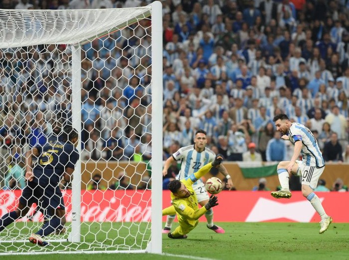 LUSAIL CITY, QATAR - DECEMBER 18: Lionel Messi of Argentina scores the team's third goal past Hugo Lloris of France during the FIFA World Cup Qatar 2022 Final match between Argentina and France at Lusail Stadium on December 18, 2022 in Lusail City, Qatar. (Photo by David Ramos - FIFA/FIFA via Getty Images)