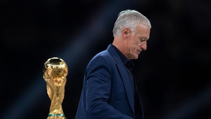 LUSAIL CITY, QATAR - DECEMBER 18: France manager Didier Deschamps walks past the FIFA World Cup Winners trophy following the FIFA World Cup Qatar 2022 Final match between Argentina and France at Lusail Stadium on December 18, 2022 in Lusail City, Qatar. (Photo by Visionhaus/Getty Images)
