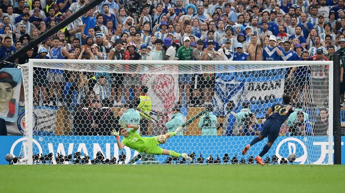 LUSAIL CITY, QATAR - DECEMBER 18: Emiliano Martinez of Argentina saves the second penalty from Kingsley Coman of France in the penalty shoot out  during the FIFA World Cup Qatar 2022 Final match between Argentina and France at Lusail Stadium on December 18, 2022 in Lusail City, Qatar. (Photo by Dan Mullan/Getty Images)