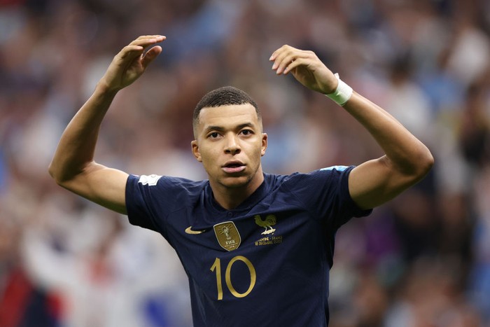 LUSAIL CITY, QATAR - DECEMBER 18: Kylian Mbappe of France celebrates after scoring the teams third goal and their hat trick from the penalty spot during the FIFA World Cup Qatar 2022 Final match between Argentina and France at Lusail Stadium on December 18, 2022 in Lusail City, Qatar. (Photo by Catherine Ivill/Getty Images)