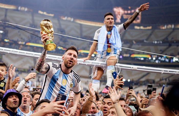 LUSAIL CITY, QATAR - DECEMBER 18: Lionel Messi of Argentina lifts the Fifa World Cup Trophy with Lautaro Martinez after winning the FIFA World Cup Qatar 2022 Final match between Argentina and France at Lusail Stadium on December 18, 2022 in Lusail Ci