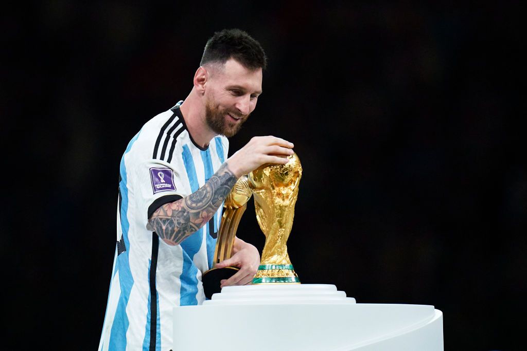 LUSAIL CITY, QATAR - DECEMBER 18: Lionel Messi of Argentina touches the trophy after the FIFA World Cup Qatar 2022 Final match between Argentina and France at Lusail Stadium on December 18, 2022 in Lusail City, Qatar. (Photo by Quality Sport Images/Getty Images)