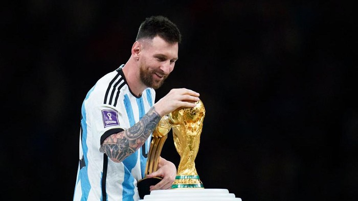 LUSAIL CITY, QATAR - DECEMBER 18: Lionel Messi of Argentina touches the trophy after the FIFA World Cup Qatar 2022 Final match between Argentina and France at Lusail Stadium on December 18, 2022 in Lusail City, Qatar. (Photo by Quality Sport Images/Getty Images)
