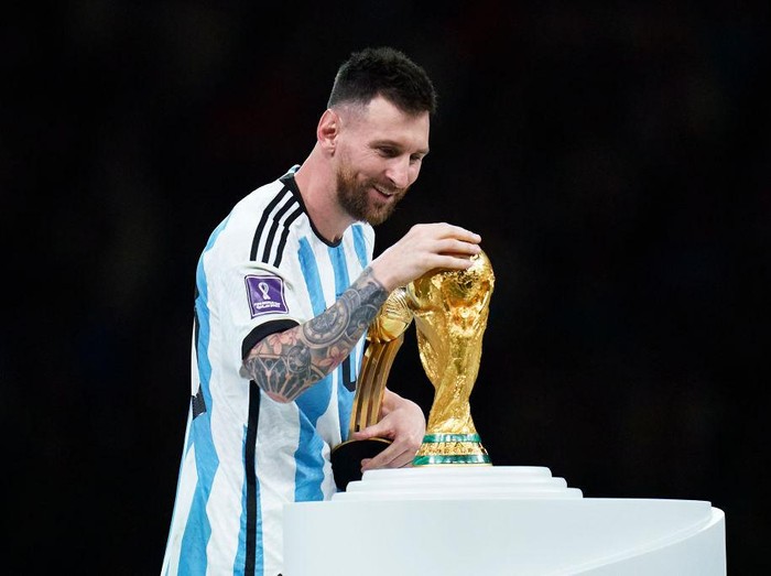 LUSAIL CITY, QATAR - DECEMBER 18: Lionel Messi of Argentina touches the trophy after the FIFA World Cup Qatar 2022 Final match between Argentina and France at Lusail Stadium on December 18, 2022 in Lusail City, Qatar. (Photo by Quality Sport Images/Getty Images)