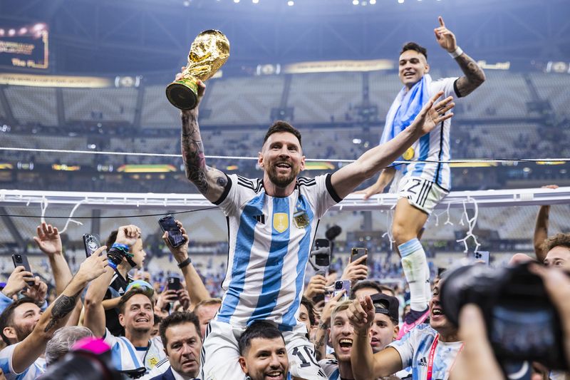 Lionel Messi 18 December 2022, Qatar, Lusail: Soccer: World Cup, Argentina - France, final round, final, Lusail Stadium, Argentina's Lionel Messi (l) and Lautaro Martínez celebrate with the World Cup trophy. Photo: Tom Weller/dpa (Photo by Tom Weller/picture alliance via Getty Images)