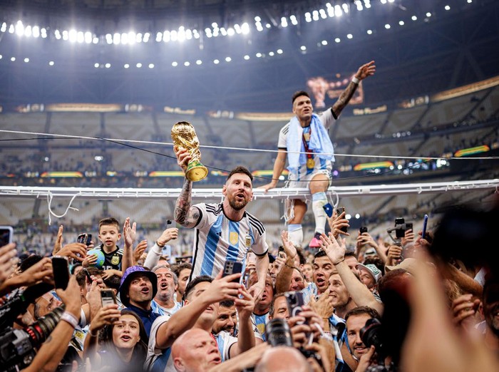 LUSAIL CITY, QATAR - DECEMBER 18: Lionel Messi of Argentina lifts the Fifa World Cup Trophy with Lautaro Martinez after winning the FIFA World Cup Qatar 2022 Final match between Argentina and France at Lusail Stadium on December 18, 2022 in Lusail City, Qatar. (Photo by MB Media/Getty Images)
