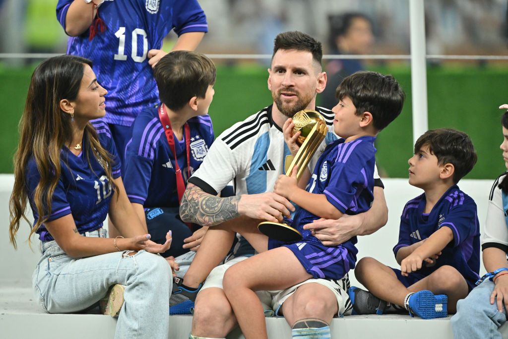 LUSAIL CITY, QATAR - DECEMBER 18: Lionel Messi of Argentina celebrates with his wife Antonela Roccuzzo and the FIFA World Cup Qatar 2022 Winner's Trophy following the FIFA World Cup Qatar 2022 Final match between Argentina and France at Lusail Stadium on December 18, 2022 in Lusail City, Qatar. (Photo by Shaun Botterill - FIFA/FIFA via Getty Images)