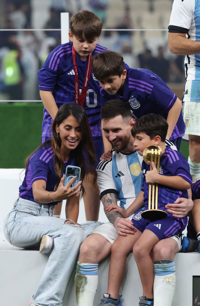 LUSAIL CITY, QATAR - DECEMBER 18: Lionel Messi of Argentina celebrates with his wife Antonela Roccuzzo and the FIFA World Cup Qatar 2022 Winner's Trophy following the FIFA World Cup Qatar 2022 Final match between Argentina and France at Lusail Stadium on December 18, 2022 in Lusail City, Qatar. (Photo by Shaun Botterill - FIFA/FIFA via Getty Images)