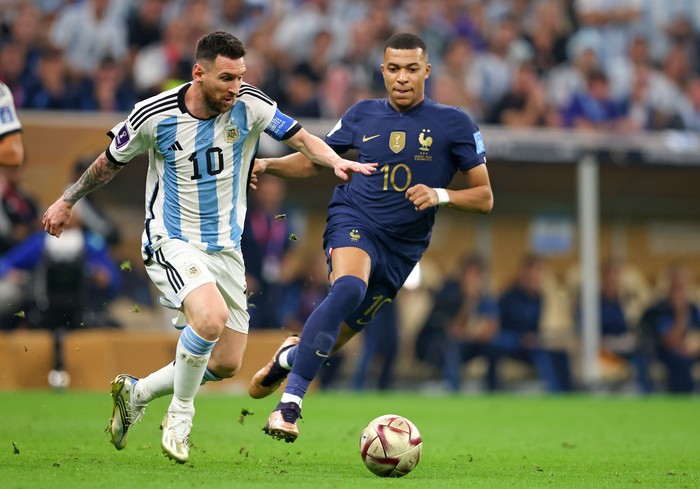 Lionel Messi, Kylian Mbappe LUSAIL CITY, QATAR - DECEMBER 18: Lionel Messi of Argentina vies with Kylian Mbappe of France during the FIFA World Cup Qatar 2022 Final match between Argentina and France at Lusail Stadium on December 18, 2022 in Lusail City, Qatar. (Photo by Stefan Matzke - sampics/Corbis via Getty Images)