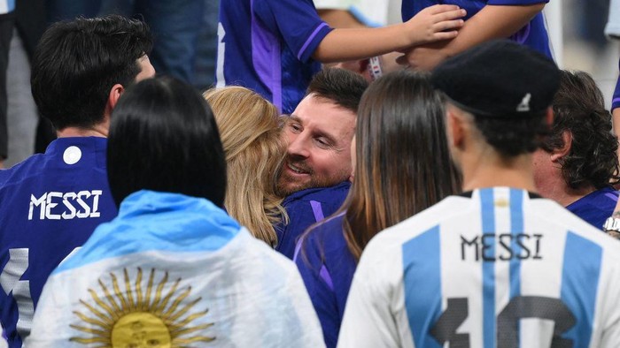 Argentina's forward #10 Lionel Messi is embraced by his mother Celia Maria Cuccittini as he celebrates after the awards ceremony after winning the Qatar 2022 World Cup football final match between Argentina and France at Lusail Stadium in Lusail, north of Doha on December 18, 2022. - Argentina won in the penalty shoot-out. (Photo by FRANCK FIFE / AFP) (Photo by FRANCK FIFE/AFP via Getty Images)
