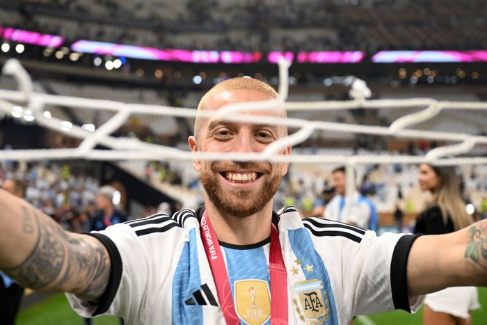 LUSAIL CITY, QATAR - DECEMBER 18: Alejandro Gomez of Argentina celebrates after the teams victory with a piece of the net during the FIFA World Cup Qatar 2022 Final match between Argentina and France at Lusail Stadium on December 18, 2022 in Lusail City, Qatar. (Photo by Michael Regan - FIFA/FIFA via Getty Images)