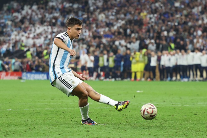 LUSAIL CITY, QATAR - DECEMBER 18: Paulo Dybala of Argentina kisses the FIFA World Cup winning trophy during the award ceremony following the FIFA World Cup Qatar 2022 Final match between Argentina and France at Lusail Stadium on December 18, 2022 in Lusail City, Qatar. (Photo by Clive Brunskill/Getty Images)
