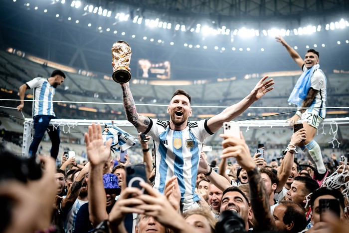 LUSAIL CITY, QATAR - DECEMBER 18: Lionel Messi of Argentina celebrates victory with the trophy after the FIFA World Cup Qatar 2022 Final match between Argentina and France at Lusail Stadium on December 18, 2022 in Lusail City, Qatar. (Photo by Marvin Ibo Guengoer - GES Sportfoto/Getty Images)
