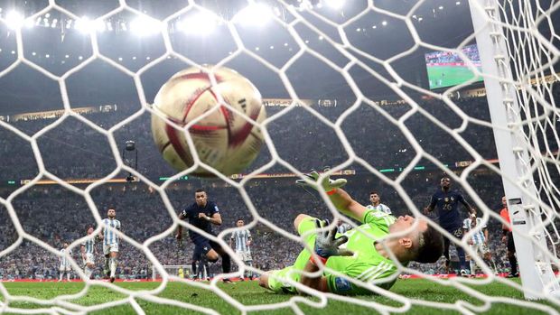 LUSAIL CITY, QATAR - DECEMBER 18: (EDITORS NOTE: In this photo taken from a remote camera from behind the goal) Kylian Mbappe of France scores the team's first goal from the penalty spot past Emiliano Martinez of Argentina during the FIFA World Cup Qatar 2022 Final match between Argentina and France at Lusail Stadium on December 18, 2022 in Lusail City, Qatar. (Photo by Catherine Ivill/Getty Images)