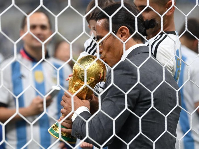 LUSAIL CITY, QATAR - DECEMBER 18: Nusret Goekce, nicknamed Salt Bae, kisses the FIFA World Cup Qatar 2022 Winner's Trophy after the FIFA World Cup Qatar 2022 Final match between Argentina and France at Lusail Stadium on December 18, 2022 in Lusail City, Qatar. (Photo by Dan Mullan/Getty Images)