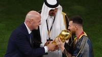 Presiden FIFA Gianni Infantino menyerahkan trofi Piala Dunia kepada Lionel Messi dari Argentina dan disaksikan oleh Emir Qatar Sheikh Tamim bin Hamad Al Thani. Reuters/Paul Childs 