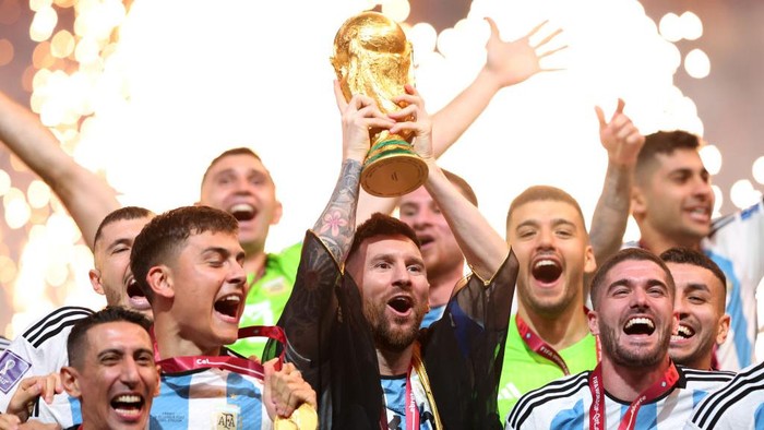 LUSAIL CITY, QATAR - DECEMBER 18: Lionel Messi, Captain of Argentina lifts the FIFA World Cup Trophy following his team's victory in the FIFA World Cup Qatar 2022 Final match between Argentina and France at Lusail Stadium on December 18, 2022 in Lusail City, Qatar. (Photo by Marc Atkins/Getty Images)