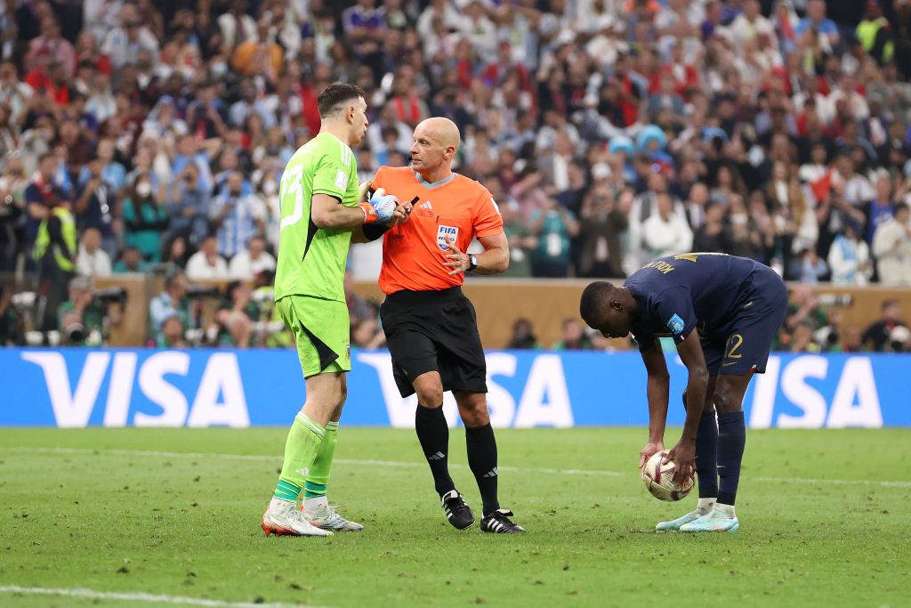 LUSAIL CITY, QATAR - DECEMBER 18: Emiliano Martinez of Argentina is prevented by referee Szymon Marciniak from speaking to Randal Kolo Muani of France in the penalty shootout during the FIFA World Cup Qatar 2022 Final match between Argentina and France at Lusail Stadium on December 18, 2022 in Lusail City, Qatar. (Photo by Julian Finney/Getty Images)