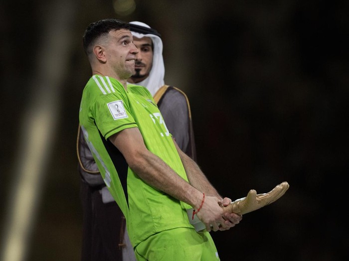 LUSAIL CITY, QATAR - DECEMBER 18: Argentina goalkeeper Emiliano Martinez with his Golden Gloves trophy after the FIFA World Cup Qatar 2022 Final match between Argentina and France at Lusail Stadium on December 18, 2022 in Lusail City, Qatar. (Photo by Visionhaus/Getty Images)