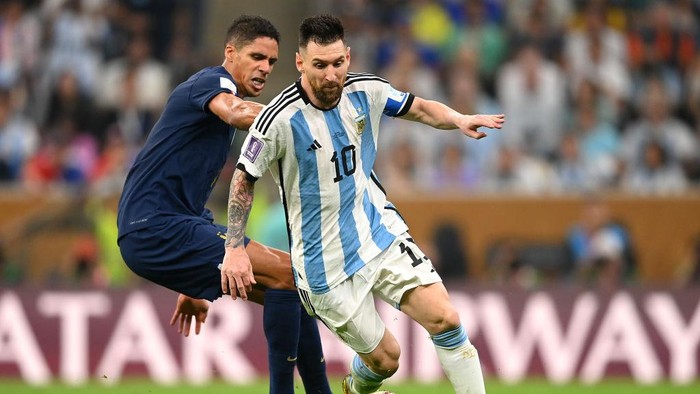 LUSAIL CITY, QATAR - DECEMBER 18: Lionel Messi of Argentina controls the ball against Raphael Varane of France during the FIFA World Cup Qatar 2022 Final match between Argentina and France at Lusail Stadium on December 18, 2022 in Lusail City, Qatar. (Photo by Michael Regan - FIFA/FIFA via Getty Images)