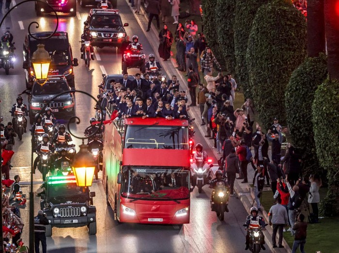 Supporters light flares and cheer as Morocco's national football team arrives to the center of the capital Rabat, on December 20, 2022, after the Qatar 2022 World Cup. (Photo by FADEL SENNA / AFP) (Photo by FADEL SENNA/AFP via Getty Images)