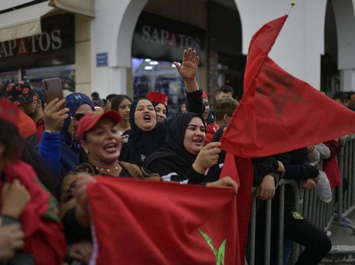 Supporters light flares and cheer as Morocco's national football team arrives to the center of the capital Rabat, on December 20, 2022, after the Qatar 2022 World Cup. (Photo by FADEL SENNA / AFP) (Photo by FADEL SENNA/AFP via Getty Images)