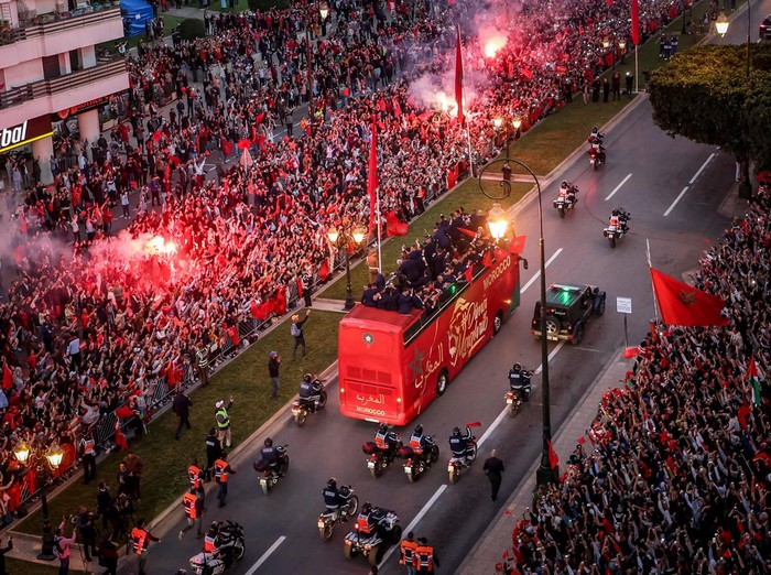 Supporters light flares and cheer as Morocco's national football team arrives to the center of the capital Rabat, on December 20, 2022, after the Qatar 2022 World Cup. (Photo by FADEL SENNA / AFP) (Photo by FADEL SENNA/AFP via Getty Images)