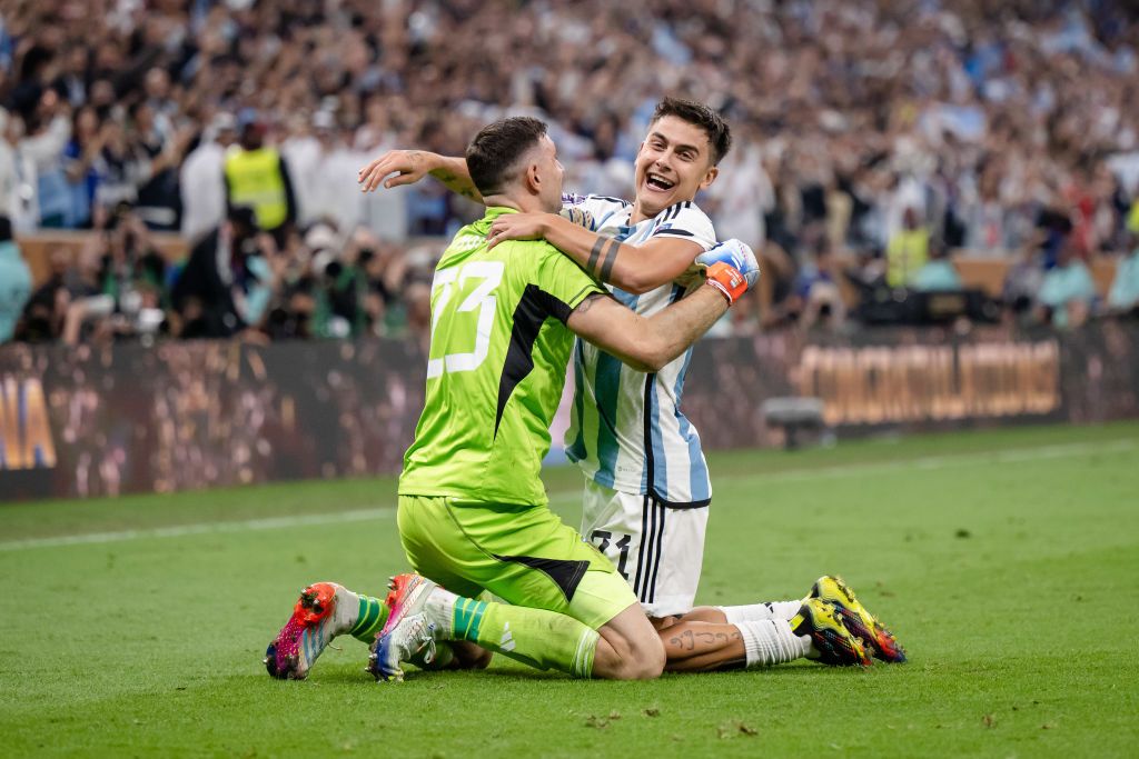 LUSAIL CITY, QATAR - DECEMBER 18: Emiliano Martinez (L) and Paulo Dybala (R) of Argentina celebrating victory after the FIFA World Cup Qatar 2022 Final match between Argentina and France at Lusail Stadium on December 18, 2022 in Lusail City, Qatar. (Photo by Marvin Ibo Guengoer - GES Sportfoto/Getty Images)