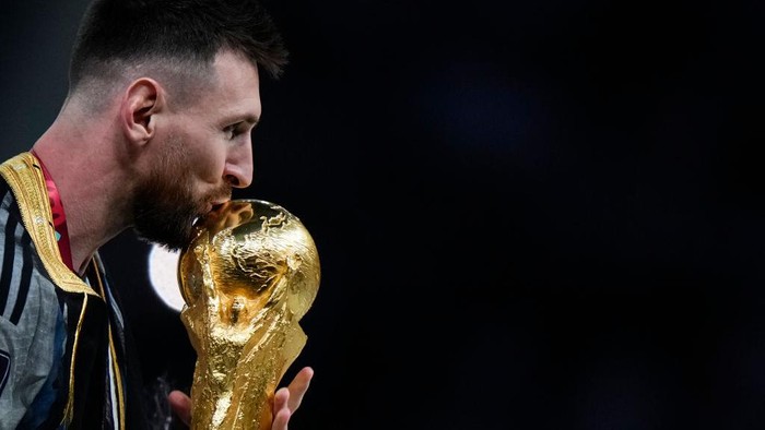 Lionel Messi right winger of Argentina and Paris Saint-Germain kisses the trophy after winning with his team the FIFA World Cup Qatar 2022 Final match between Argentina and France at Lusail Stadium on December 18, 2022 in Lusail City, Qatar. (Photo by Jose Breton/Pics Action/NurPhoto via Getty Images)