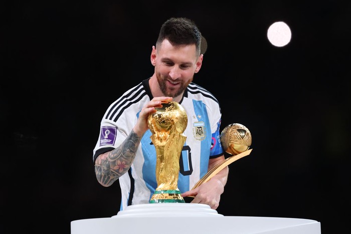 LUSAIL CITY, QATAR - DECEMBER 18: Lionel Messi of Argentina celebrates with the World Cup Trophy and player of the tournament award during the FIFA World Cup Qatar 2022 Final match between Argentina and France at Lusail Stadium on December 18, 2022 in Lusail City, Qatar. (Photo by Marc Atkins/Getty Images)