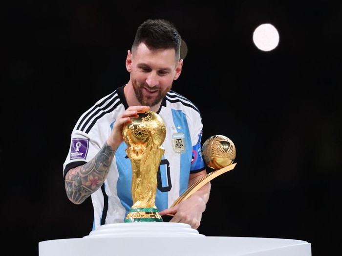 LUSAIL CITY, QATAR - DECEMBER 18: Lionel Messi of Argentina celebrates with the World Cup Trophy and player of the tournament award during the FIFA World Cup Qatar 2022 Final match between Argentina and France at Lusail Stadium on December 18, 2022 in Lusail City, Qatar. (Photo by Marc Atkins/Getty Images)