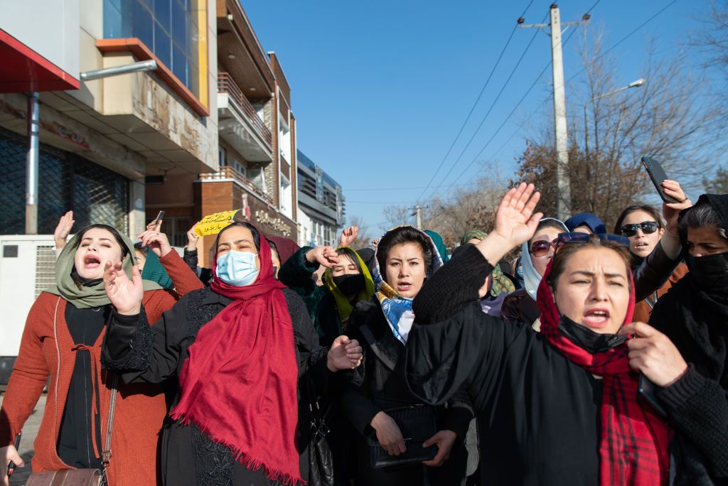 KABUL, AFGHANISTAN - DECEMBER 22:  Afghan women protest against new Taliban ban on women accessing University Education on December 22, 2022 in Kabul, Afghanistan. A group of Afghan women rallied in Kabul against a governmental order banning women from universities. Armed guards barred women from accessing university sites since the suspension was announced on December 20. (Photo by Stringer/Getty Images)
