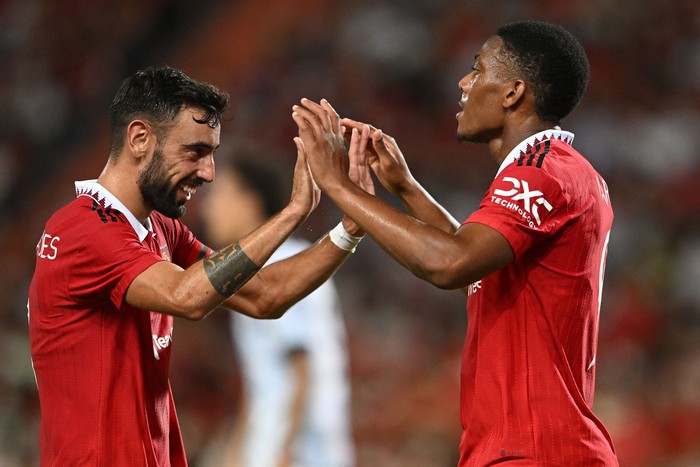 Manchester United's French striker Anthony Martial (R) and Manchester United's Portuguese midfielder Bruno Fernandes celebrate during the exhibition football match between English Premier League teams Manchester United and Liverpool FC at Rajamangala National Stadium in Bangkok on July 12, 2022. (Photo by MANAN VATSYAYANA / AFP) (Photo by MANAN VATSYAYANA/AFP via Getty Images)