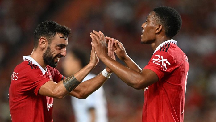 Manchester Uniteds French striker Anthony Martial (R) and Manchester Uniteds Portuguese midfielder Bruno Fernandes celebrate during the exhibition football match between English Premier League teams Manchester United and Liverpool FC at Rajamangala National Stadium in Bangkok on July 12, 2022. (Photo by MANAN VATSYAYANA / AFP) (Photo by MANAN VATSYAYANA/AFP via Getty Images)