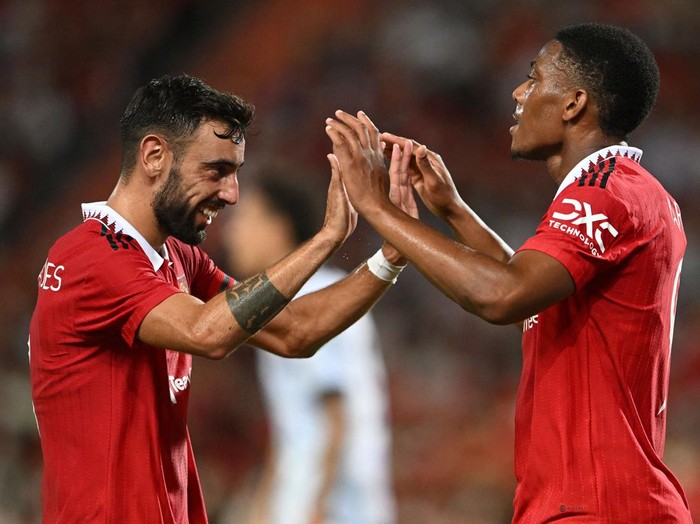 Manchester United's French striker Anthony Martial (R) and Manchester United's Portuguese midfielder Bruno Fernandes celebrate during the exhibition football match between English Premier League teams Manchester United and Liverpool FC at Rajamangala National Stadium in Bangkok on July 12, 2022. (Photo by MANAN VATSYAYANA / AFP) (Photo by MANAN VATSYAYANA/AFP via Getty Images)
