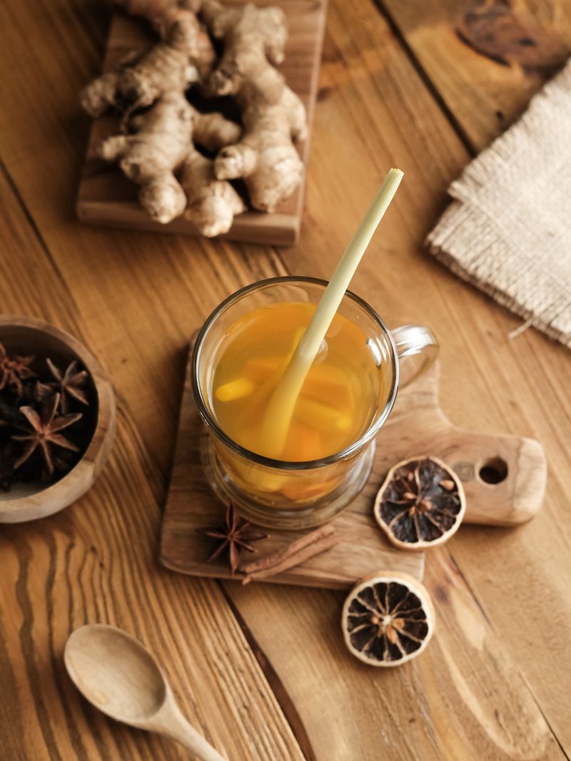 Empon-empon, Rimpang or Jamu, Indonesian traditional herbal drink, made from ginger, turmeric, and other herbs. Served in glass on wooden table, selective image and blurred background.