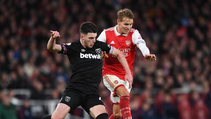 LONDON, ENGLAND - DECEMBER 26: Martin Odegaard of Arsenal challenges Declan Rice of West Ham during the Premier League match between Arsenal FC and West Ham United at Emirates Stadium on December 26, 2022 in London, England. (Photo by David Price/Arsenal FC via Getty Images)
